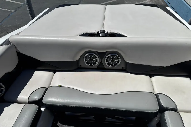 Slide: The Image of 2015 Axis A20 boat interior with gray seating and built-in speakers. - 22