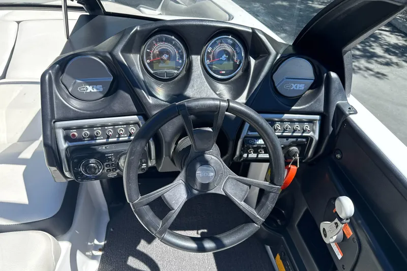 Slide: The Image of Dashboard of a 2015 Axis A20 boat with steering wheel and control panels. - 15