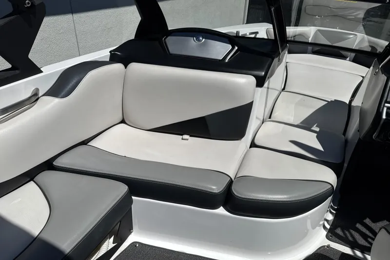 Slide: The Image of 2015 Axis A20 boat interior with gray and white cushioned seating. - 19