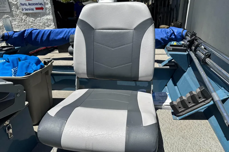 Slide: The Image of Gray seat on a 2004 Klamath 16 Alaskan boat, surrounded by fishing gear. - 16