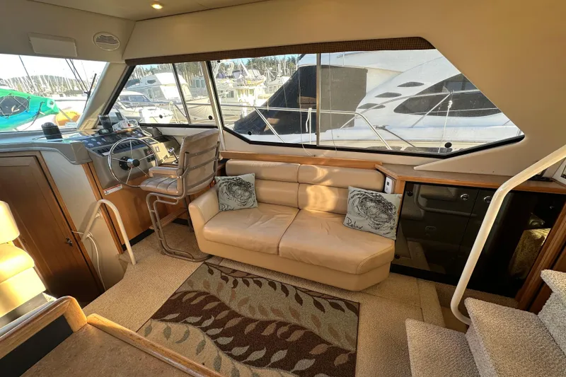Slide: The Image of Interior of 2000 Bayliner 4087 Aft Cabin Motoryacht with helm, seating, and large windows. - 5