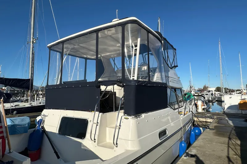 Slide: The Image of 2000 Bayliner 4087 Aft Cabin Motoryacht docked at marina under clear blue sky. - 11