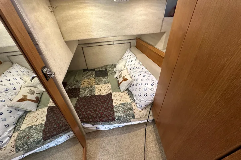 Slide: The Image of Cozy cabin bedroom in 2000 Bayliner 4087 Aft Cabin Motoryacht with nautical-themed bedding. - 34