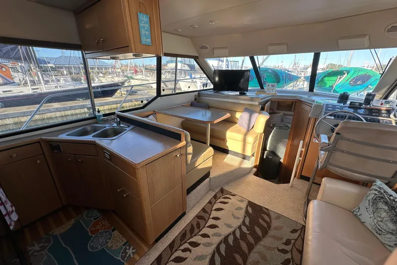 Slide: The Image of Interior of 2000 Bayliner 4087 Aft Cabin Motoryacht with kitchen, seating, and helm. - 4