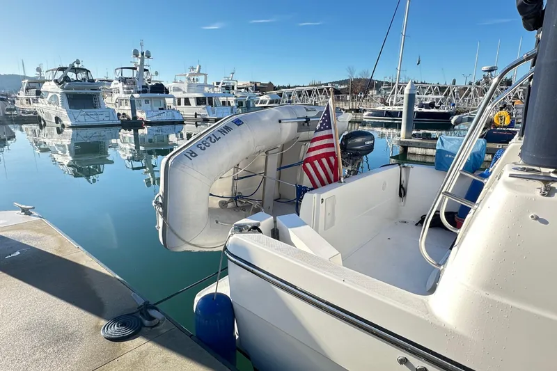Slide: The Image of Bayliner 4087 Aft Cabin Motoryacht 2000 docked with inflatable boat and American flag. - 7