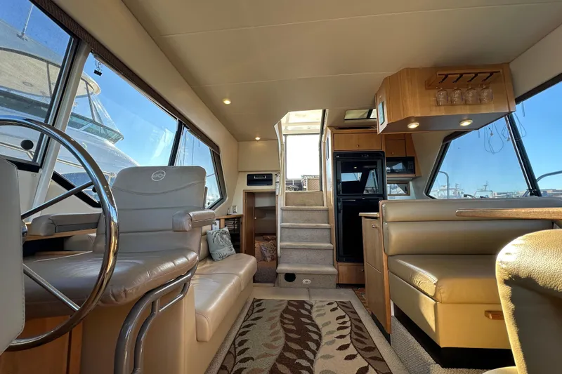 Slide: The Image of Interior of 2000 Bayliner 4087 Aft Cabin Motoryacht, featuring helm, seating, and dining area. - 6