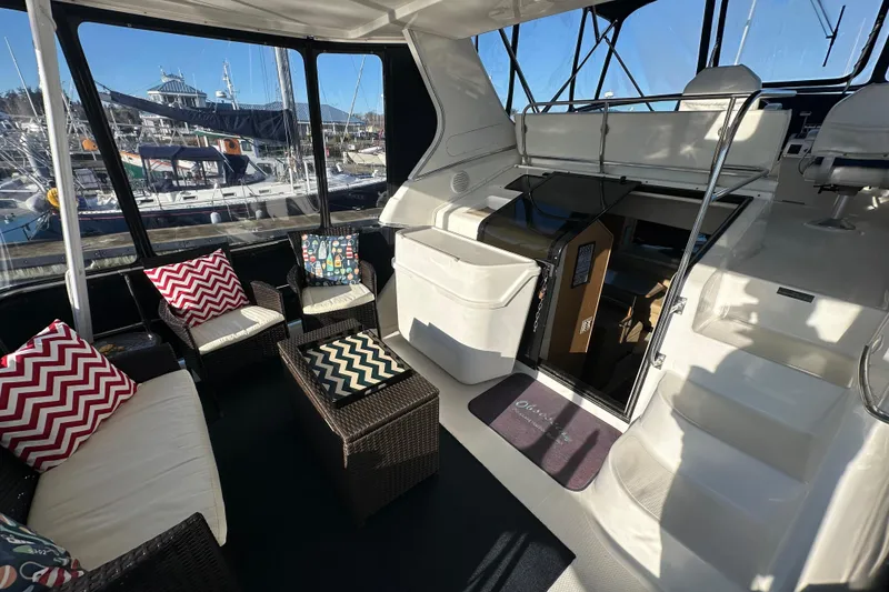 Slide: The Image of 2000 Bayliner 4087 Aft Cabin Motoryacht interior with seating and marina view. - 3
