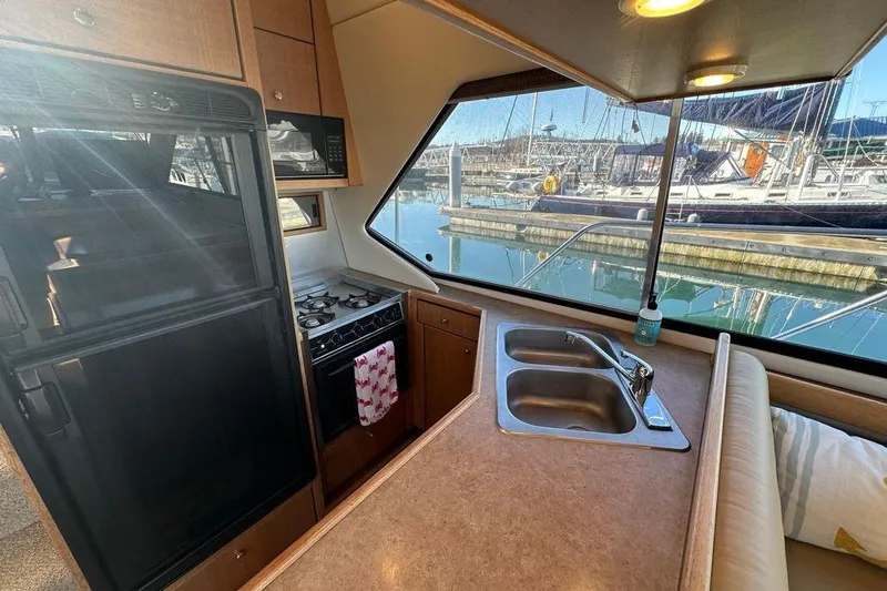 Slide: The Image of Interior of 2000 Bayliner 4087 Aft Cabin Motoryacht with kitchen and marina view. - 8