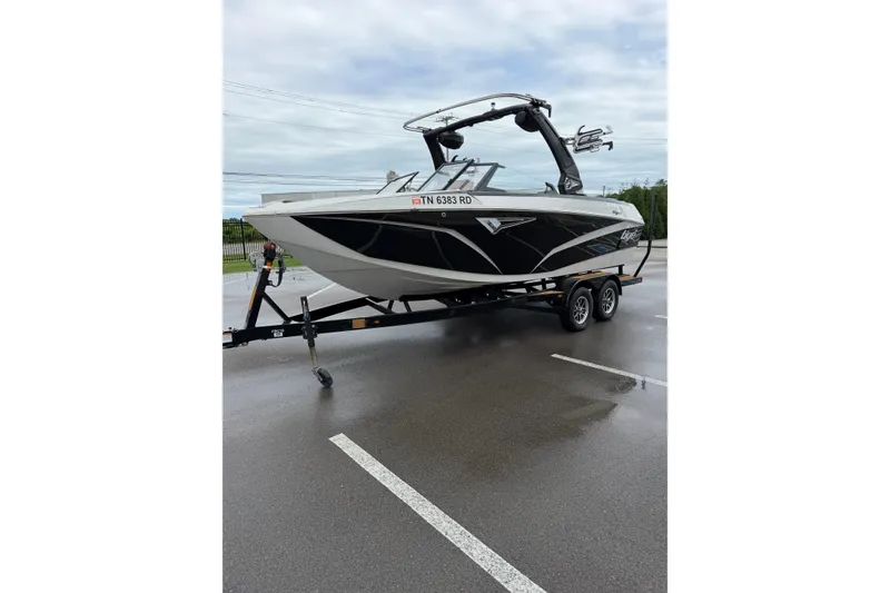 Slide: The Image of 2023 Tigé Z1 boat on trailer in parking lot, overcast sky. - 4