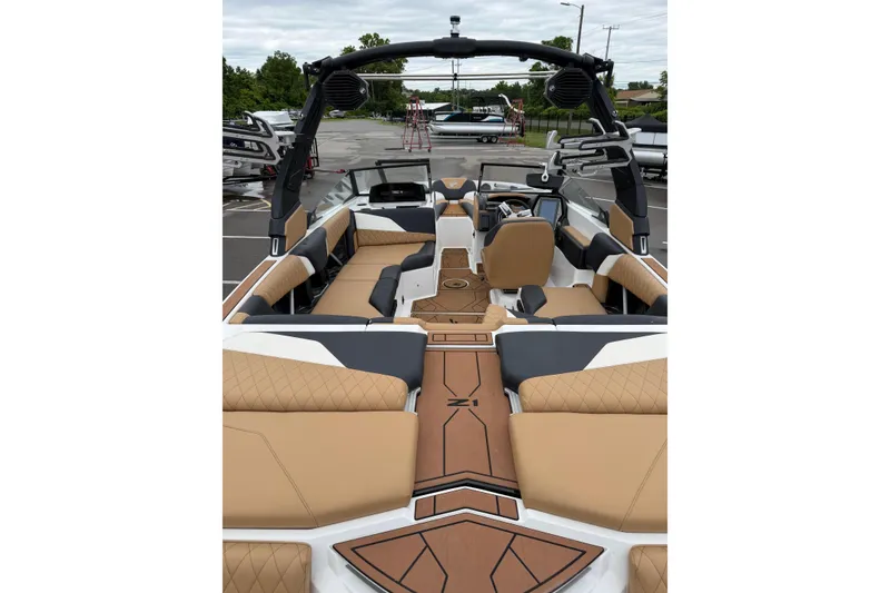 Slide: The Image of 2023 Tigé Z1 boat interior with tan and black seating, modern dashboard, and spacious layout. - 6