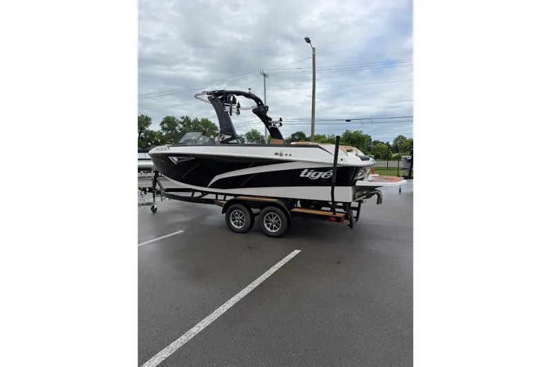 Slide: The Image of 2023 Tigé Z1 boat on trailer in parking lot, overcast sky. - 3