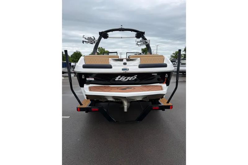 Slide: The Image of 2023 Tigé Z1 boat rear view with sleek design and wakeboard tower. - 2