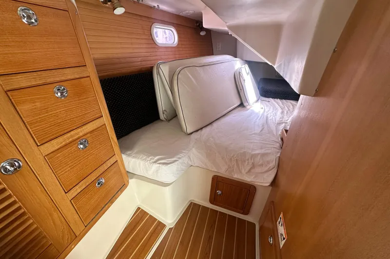 Slide: The Image of Cozy cabin interior of 2005 Catalina 36 MkII sailboat with wooden cabinetry and bedding. - 14