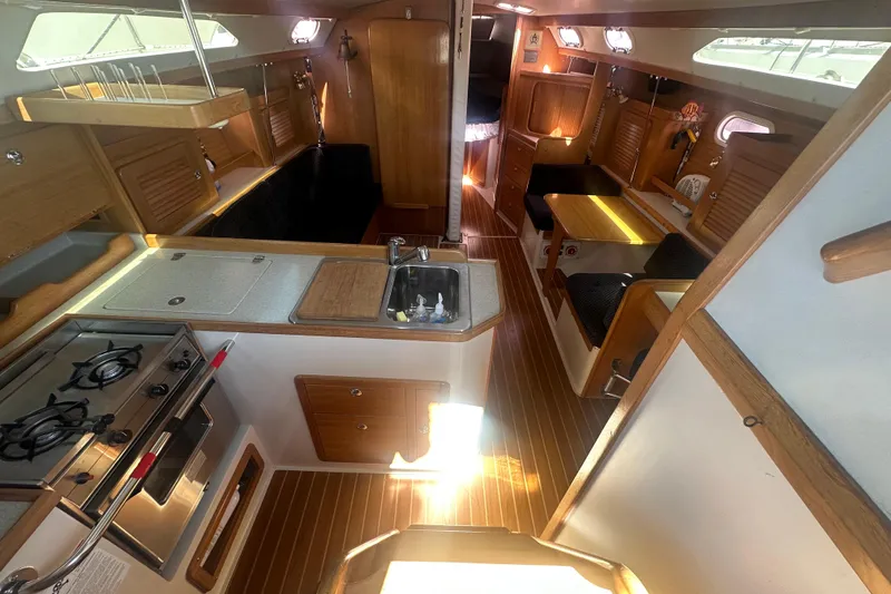 Slide: The Image of Interior of 2005 Catalina 36 MkII sailboat with kitchen, dining area, and wooden finishes. - 15