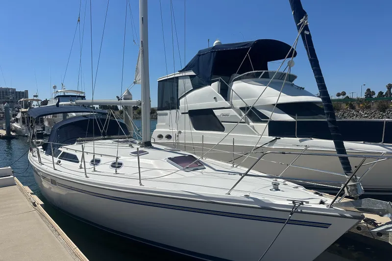 The Image of 2005 Catalina 36 MkII sailboat docked at marina under clear blue sky. - 0