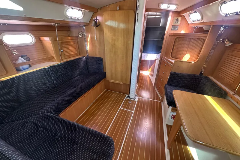 Slide: The Image of Interior of a 2005 Catalina 36 MkII sailboat with wood finish and seating area. - 4