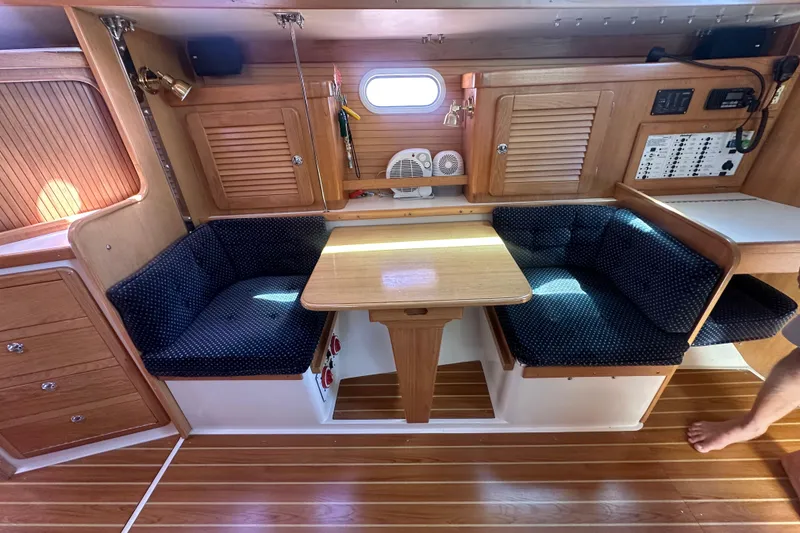 Slide: The Image of Interior of 2005 Catalina 36 MkII sailboat with wooden cabinetry and cozy seating area. - 6
