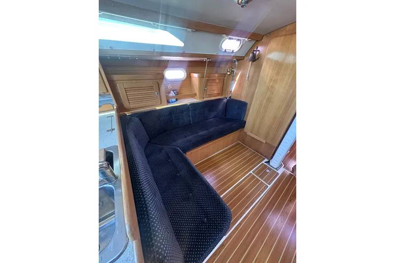 Slide: The Image of Interior of 2005 Catalina 36 MkII sailboat with wooden flooring and cozy seating area. - 9