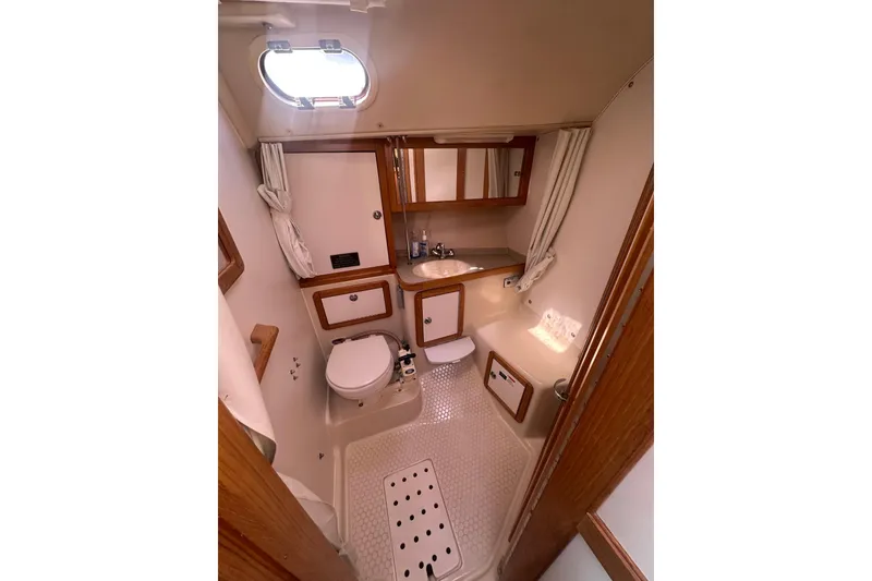 Slide: The Image of Bathroom interior of 2005 Catalina 36 MkII sailboat, featuring compact design and wooden accents. - 11