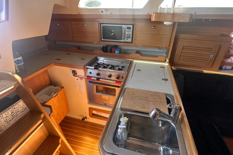 Slide: The Image of Cozy galley kitchen in 2005 Catalina 36 MkII sailboat with stove, sink, and microwave. - 5