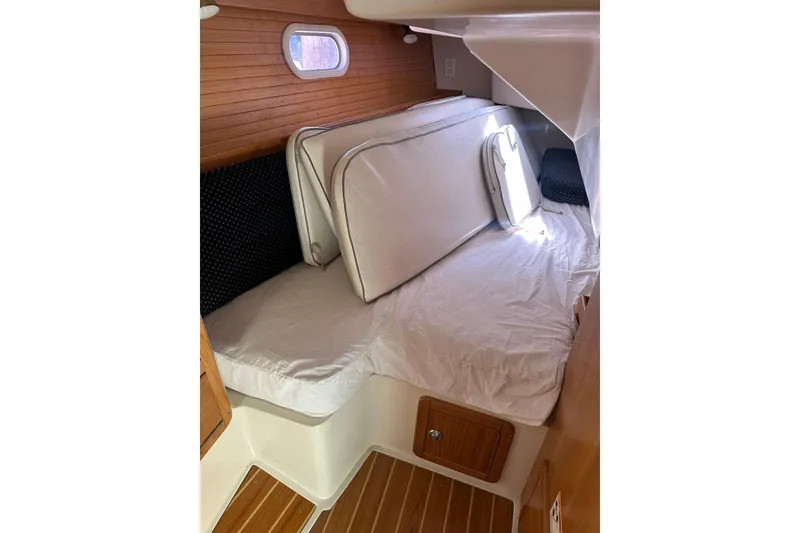 Slide: The Image of Interior cabin of 2005 Catalina 36 MkII sailboat with cushions and wooden accents. - 13