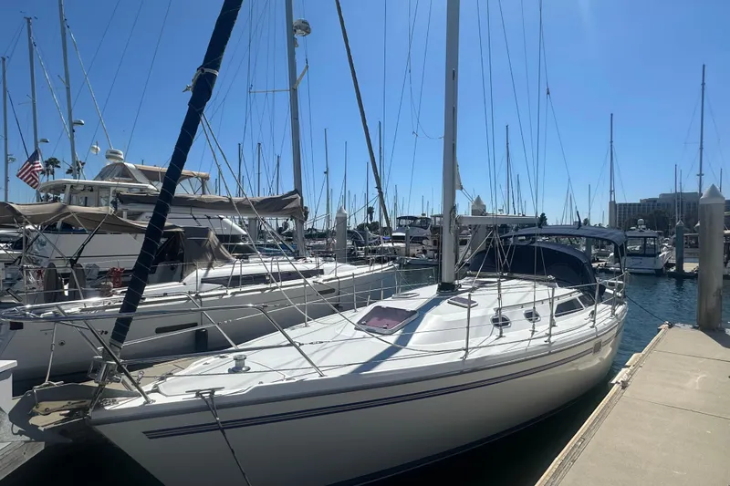 Slide: The Image of 2005 Catalina 36 MkII sailboat docked at a marina under clear blue skies. - 1