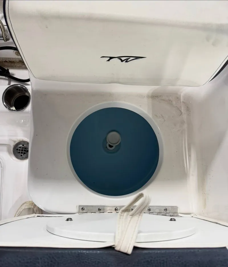 Slide: The Image of View of a boat interior with a round blue container and a white lid. - 9