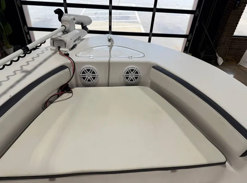 Slide: The Image of The image shows the bow of a Tidewater 180 CC Adventure boat with seating cushions and speakers. - 8