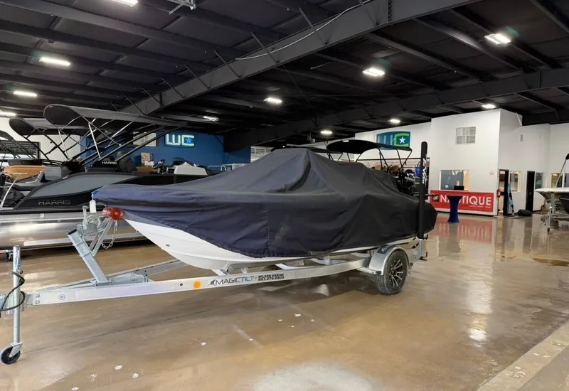 Slide: The Image of A 2024 Tidewater 180 CC Adventure boat on a trailer in a showroom. - 11