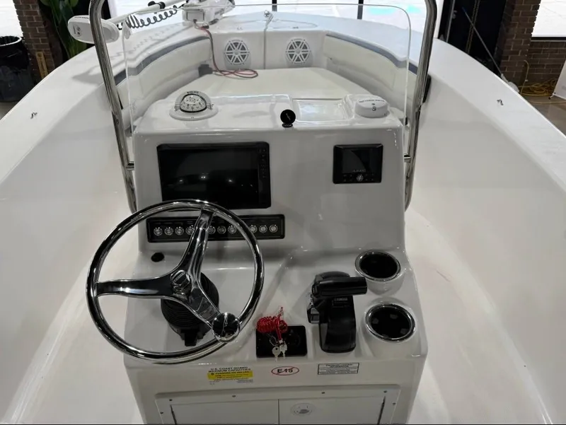 Slide: The Image of The image shows the helm of a 2024 Tidewater 180 CC Adventure boat with steering wheel and instruments. - 7
