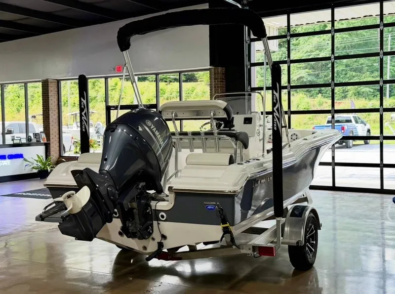 Slide: The Image of 2024 Tidewater 180 CC Adventure in a showroom with an outboard motor. - 4