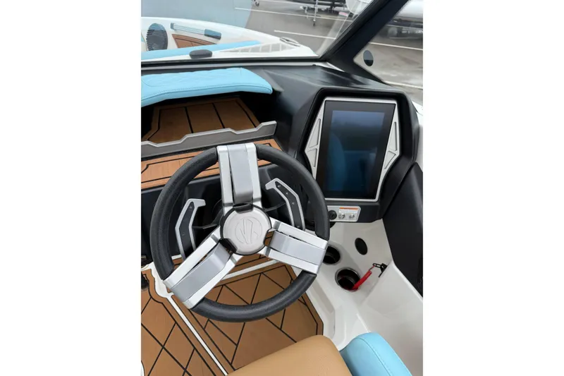 Slide: The Image of 2023 Tigé Z1 boat dashboard with modern steering wheel and touchscreen display. - 7