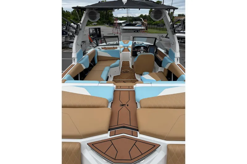 Slide: The Image of 2023 Tigé Z1 boat interior with tan and blue seating, modern design, and spacious layout. - 5