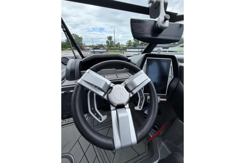 Slide: The Image of 2023 Tigé Z1 boat interior with modern steering wheel and touchscreen display. - 5