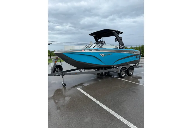 Slide: The Image of 2023 Tigé Z1 boat in blue on a trailer, parked in a wet lot. - 9