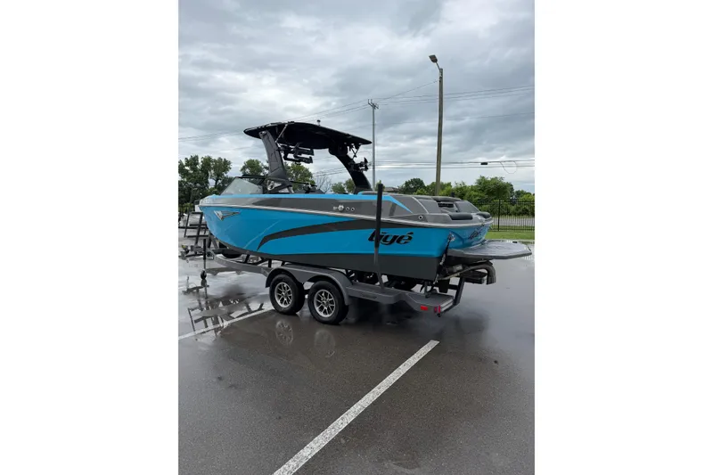 Slide: The Image of 2023 Tigé Z1 boat on trailer in parking lot, overcast sky. - 8