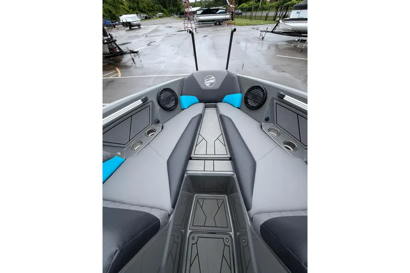 Slide: The Image of 2023 Tigé Z1 boat interior with gray and blue seating, cup holders, and speakers. - 3