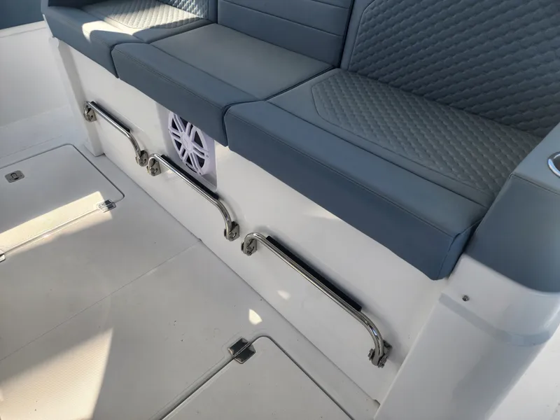 Slide: The Image of The image shows a cushioned bench seat with blue upholstery and stainless steel grab rails. - 42