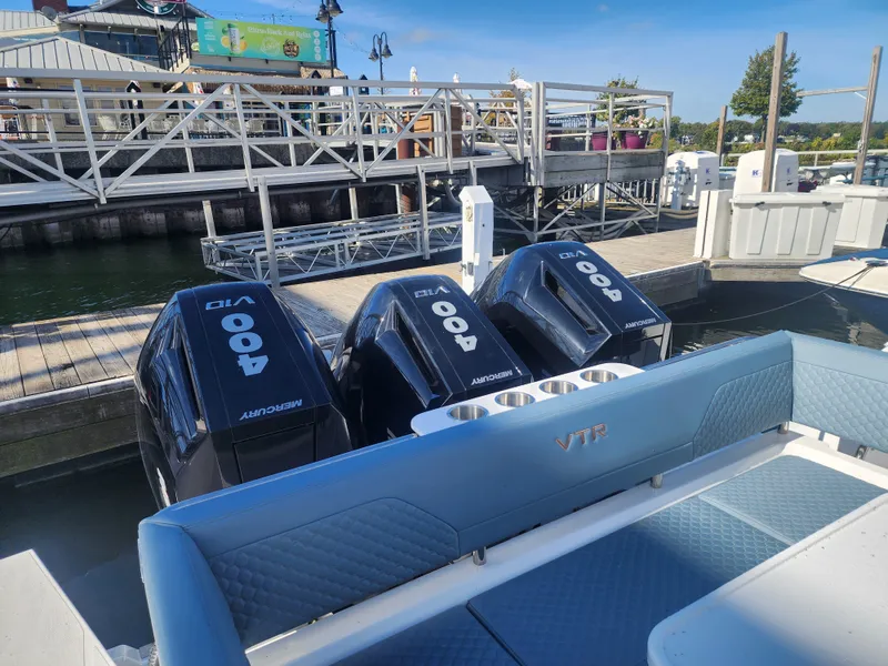 Slide: The Image of The image shows the stern of a Cruisers Yachts 45VTR with three Mercury 400 HP outboard engines. - 16