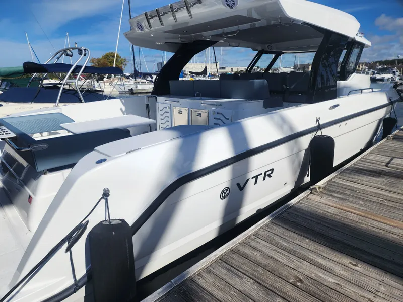 Slide: The Image of The 2027 Cruisers Yachts 45VTR is docked. It features a sleek design and spacious cabin. - 12