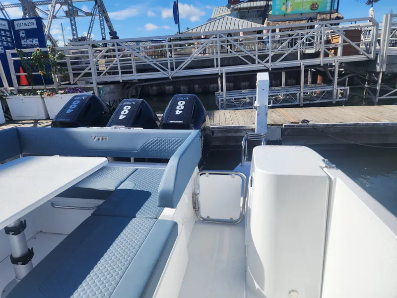 Slide: The Image of The image shows the stern of a Cruisers Yachts 45VTR with three outboard engines at the dock. - 34