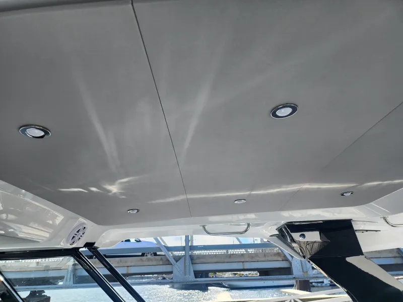 Slide: The Image of The image shows the ceiling of a Cruisers Yachts 45VTR with built-in lights and a view of a bridge. - 43