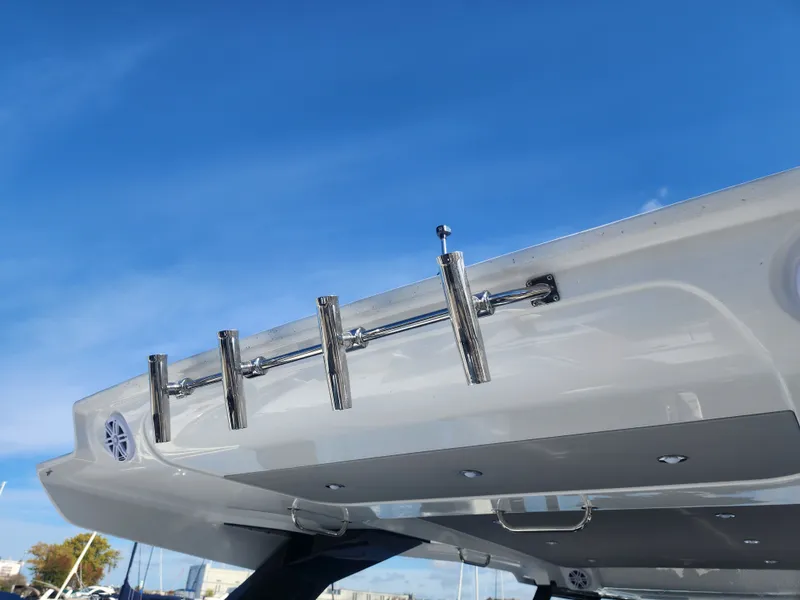 Slide: The Image of The image shows the rear of a Cruisers Yachts 45VTR with multiple fishing rod holders. - 28