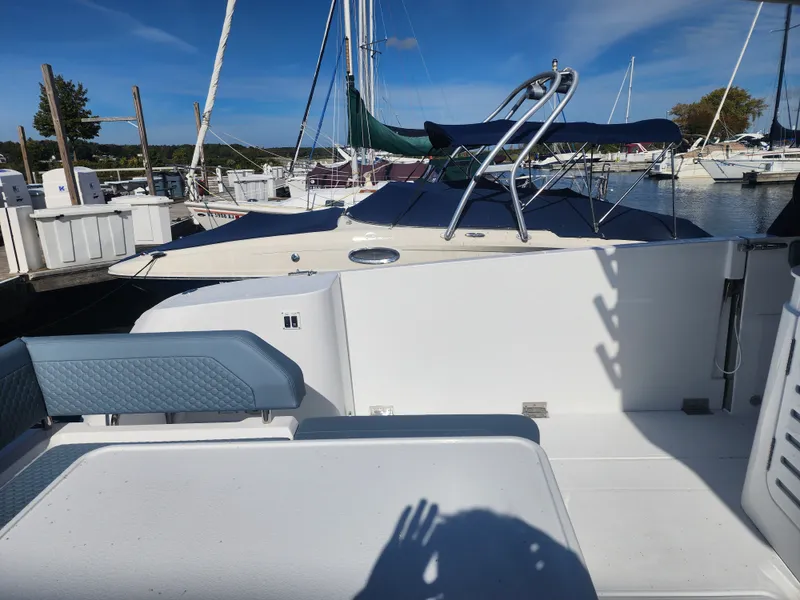 Slide: The Image of The image shows the deck of a 2027 Cruisers Yachts 45VTR at a marina. Other boats are visible in the background. - 20
