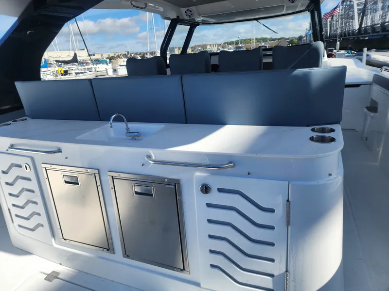 Slide: The Image of The image shows the cockpit of a 2027 Cruisers Yachts 45VTR with a modern kitchenette. - 24