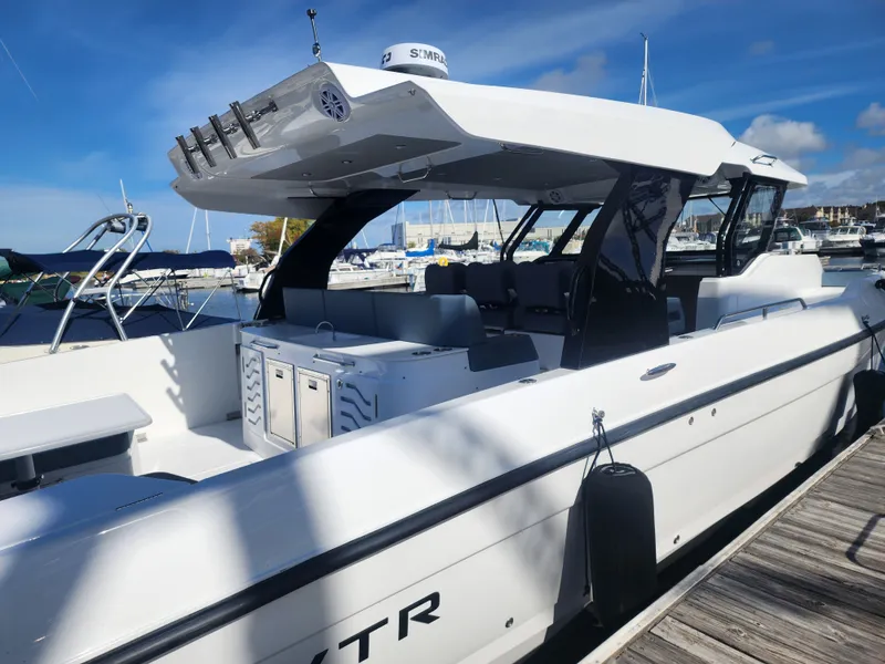Slide: The Image of The 2027 Cruisers Yachts 45VTR is docked. It features a sleek design with a spacious cockpit. - 9