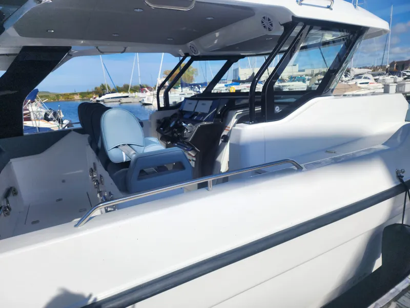 Slide: The Image of The image shows the cockpit of a 2027 Cruisers Yachts 45VTR at a marina. - 6