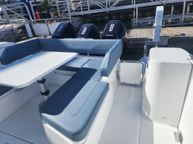 Slide: The Image of The image shows the cockpit of a 2027 Cruisers Yachts 45VTR with blue upholstery and a table. - 35