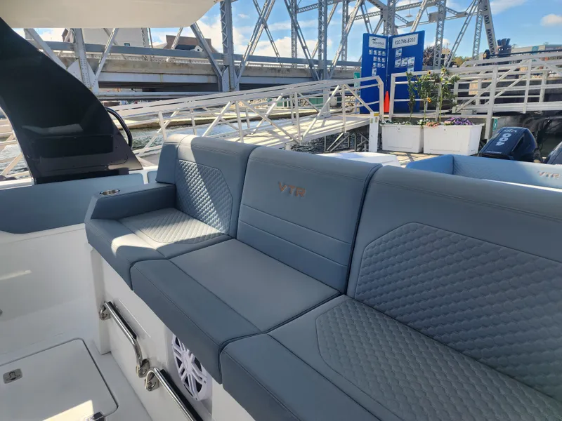 Slide: The Image of The 2027 Cruisers Yachts 45VTR features a luxurious, cushioned seating area with blue upholstery. - 41