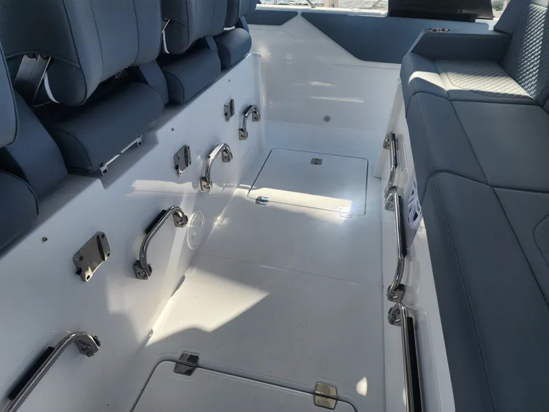 Slide: The Image of The image shows the interior of a Cruisers Yachts 45VTR with blue seating and stainless steel handles. - 46